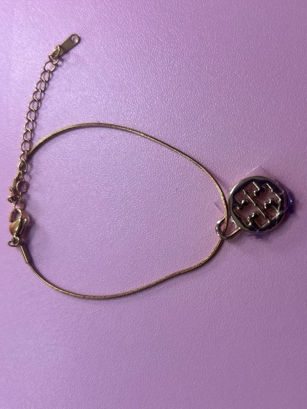 Gold Tory Burch Charm on Gold Bracelet